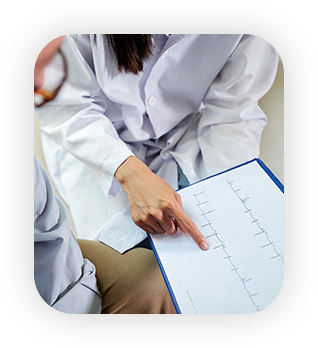 Close-up of senior man and doctor with cardiogram on clipboard meeting in medical office at hospital, doctor explaining some facts about disease