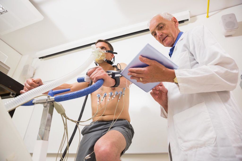 Man doing fitness test on exercise bike at the medical centre